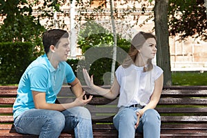 Couple sitting in park having relationship problems