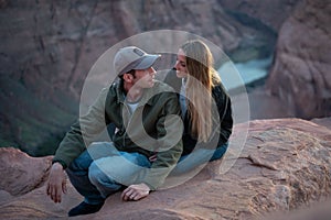 couple sitting on the rock in the desert of Horseshoe Bend, blue hour sunset, the sun goes down