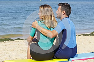 couple sitting on sand