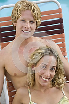 Couple Sitting On Sunlounger