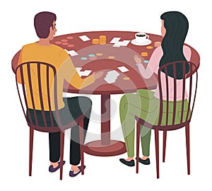 Couple sitting at table play board game at home. Family communicates during process of playing