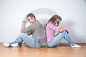 Couple sitting with their backs turned after having an argument photo