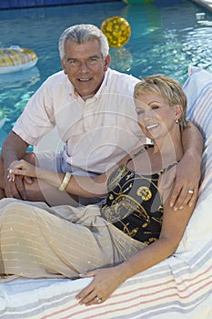 Couple Sitting Together On Deckchair