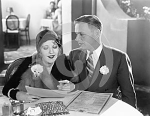 A couple sitting together at a dinner table