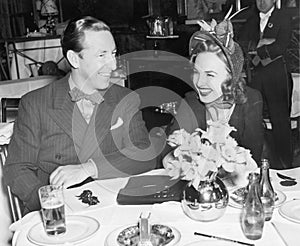 Couple sitting together at a table having fun