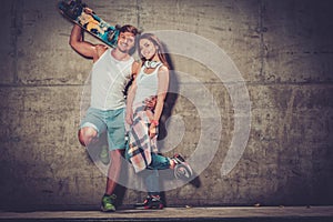 Couple with skateboard outdoors