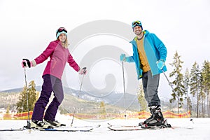 Couple of skiers on slope at resort. Winter