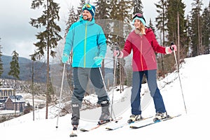 Couple of skiers on slope at resort. Winter