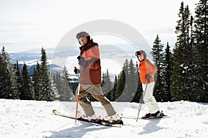 Couple Skiing on Mountain Slope photo