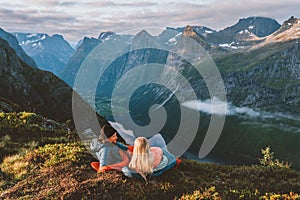 Couple in sleeping bags bivouac in mountains camping travel gear friends hiking in Norway photo
