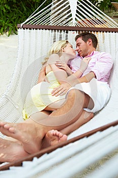 Couple Sleeping In Beach Hammock