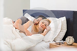 Couple sleeping on bed