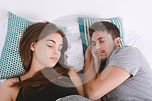 Couple sleeping in bed.