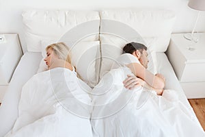Couple sleeping in bed at home
