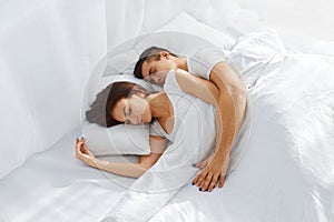 Couple sleeping in bed photo