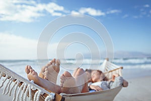 Couple sleeping on hammock at beach