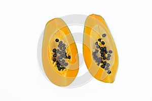 Couple of sliced pieces of fresh yellow ripe papaya fruit isolated before a white background