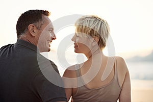 Couple, smile and beach relax at sunset in summer on tropical island for paradise, marriage or stress relief. Man, woman