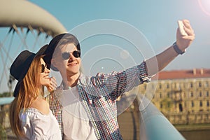 Couple smile on bridge. Tourist having fun on sumer travel adventure vacation. Happy tourists taking photo of themselves