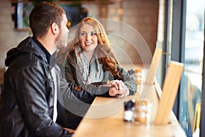 Couple, smile and holding hands in cafe with love, romance and affection on anniversary date. Romantic, man and woman in