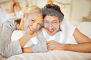 Couple, smile and portrait in bedroom for relax and unwind on day off for break or holiday indoor. Woman, man and happy