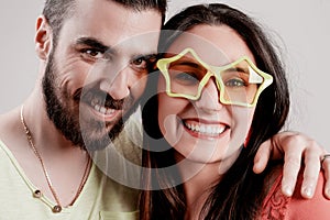 Couple smiles woman wears playful star glasses