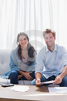 Couple smiling while doing their accounts