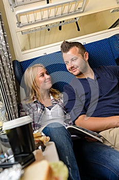 Couple smiling at each other in train