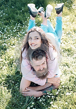 Couple on smiling faces smoking outdoors, nature on background. Smoking habit concept. Couple in love spend time