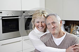 Couple Smiling In Kitchen
