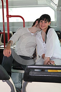 Couple smooching on a bus