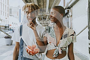 Couple snacking on fruit in the summer