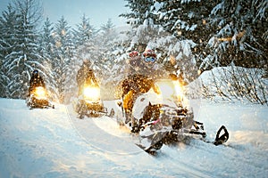 Couple snow mobile in snow storm