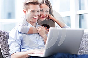 Couple on sofa with laptop