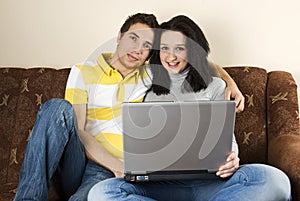 Couple on sofa using laptop