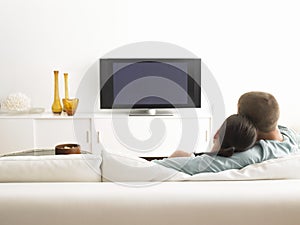 Couple On Sofa Watching TV