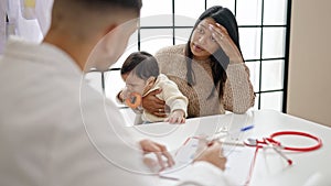 Couple and son having medical consultation at clinic