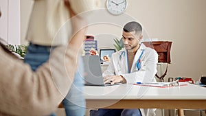 Couple and son having medical consultation using laptop at clinic