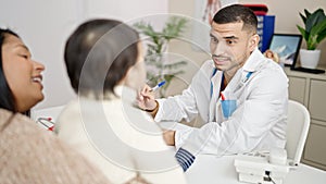 Couple and son having medical consultation writing on notebook at clinic