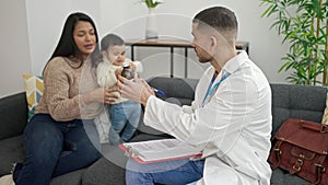 Couple and son prescribing medication at clinic