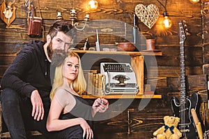 Couple spend romantic evening in gamekeepers house, wooden interior background. Romantic concept. Girl and man on calm
