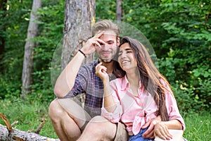 Couple spend time outdoors on sunny day. Youth on picnic or hike relaxing and having fun. Pleasant weekend. Couple