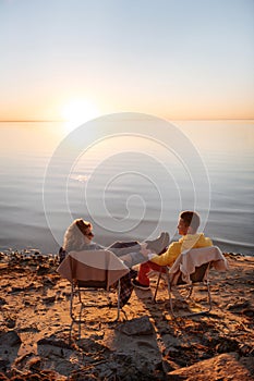 Couple spending calm and romantic evening near the water