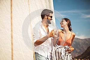 Couple spending happy time on a yacht at sea. Luxury vacation on a seaboat