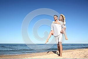 Couple spending time together on beach. Space for text