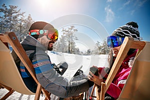 Couple spending time together and drink after skiing in cafe at