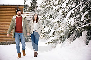 Couple spending time together on snowy day. Winter vacation