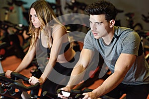 Couple in a spinning class wearing sportswear.