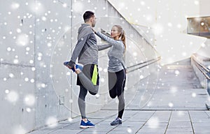 Couple of sportsmen stretching leg outdoors