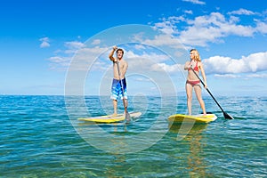 Couple Stand Up Paddle Surfing In Hawaii photo